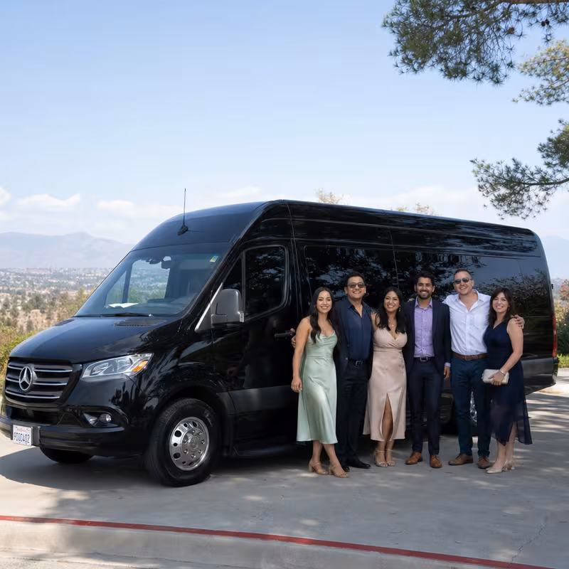 Group beside a Mercedes Sprinter limo from the Anaheim fleet