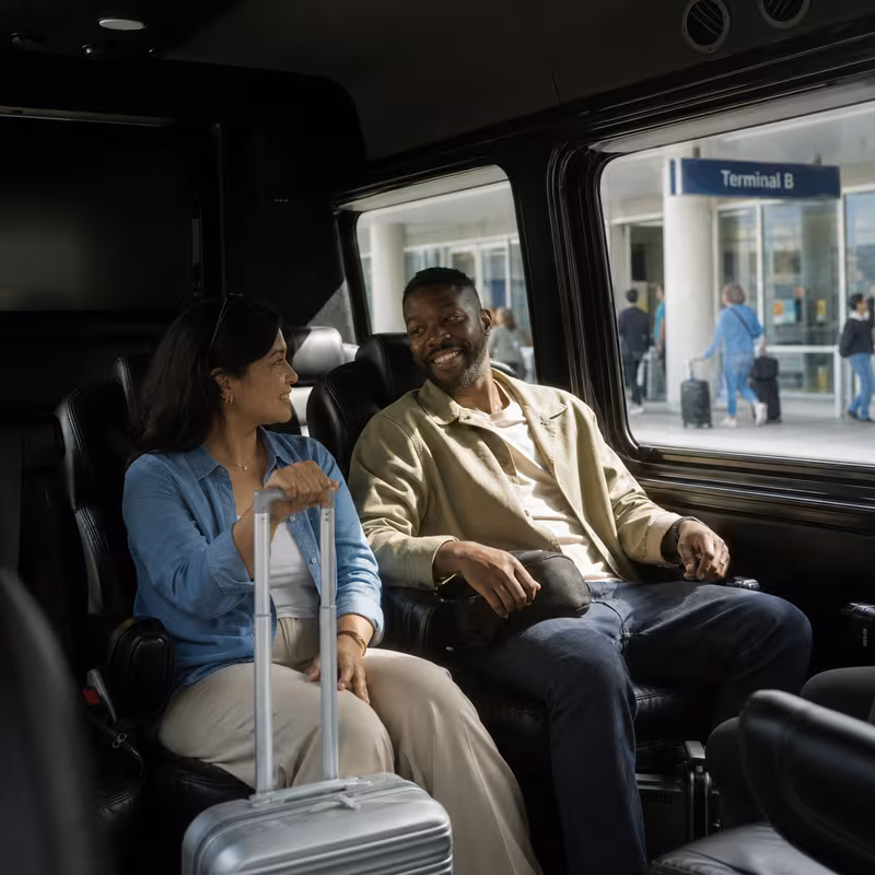 Passengers loading luggage while boarding an Anaheim group shuttle