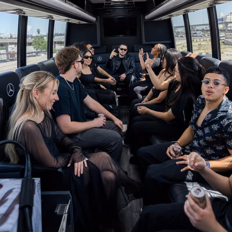Group boarding a white charter bus for Concert Transportation transportation in Anaheim