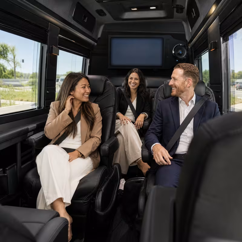 Group boarding a white charter bus for Corporate Transportation transportation in Anaheim