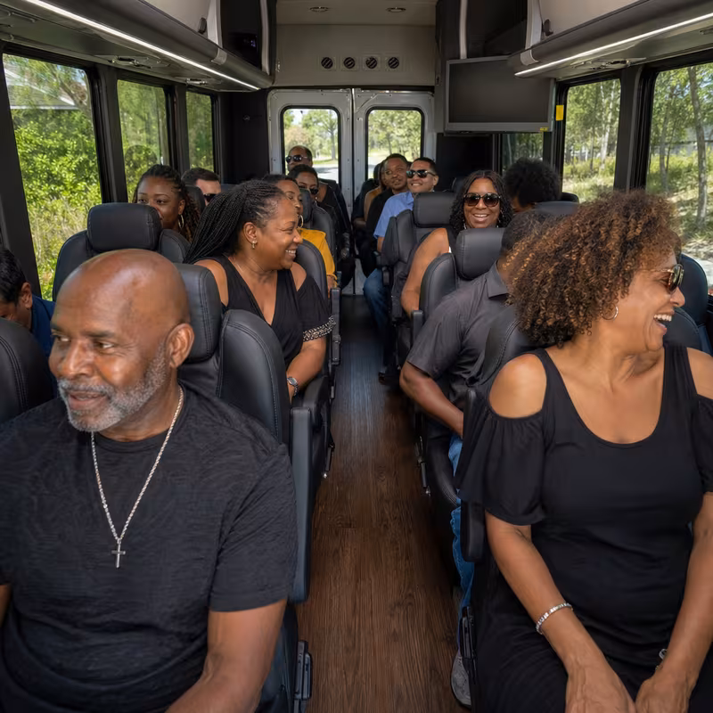 Group boarding a white charter bus for Private Event Transportation transportation in Anaheim