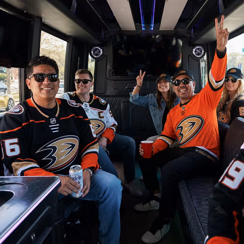 Group boarding a white charter bus for Sporting Event Transportation transportation in Anaheim