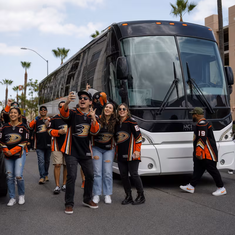 Passengers loading luggage while boarding an Anaheim group shuttle