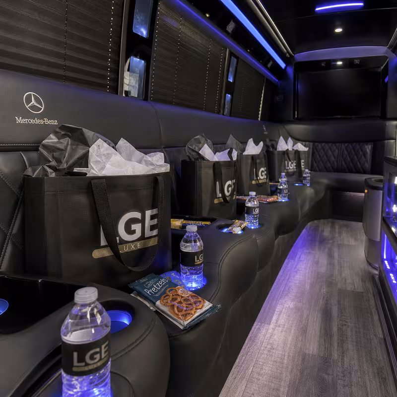 Party bus interior with wraparound leather seating and LED lighting in Anaheim